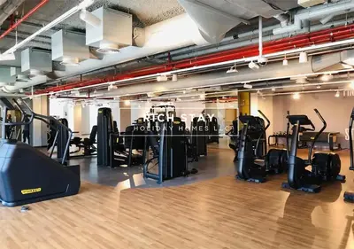 a gym with treadmills and elliptical machines at Incredible 1BR, Downtown Views II near Dubai Mall in Dubai