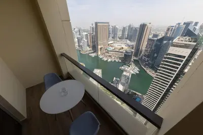 a room with two chairs and a view of a city at Luxury Living on the Top Floor Full Marina View in Dubai