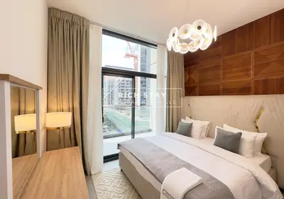a bedroom with a large bed and a large window at Exceptional 1 BR in Prive Residences Dubai Hills in Dubai
