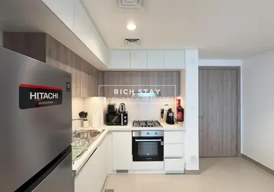 a kitchen with a stove and a refrigerator at Exceptional 1 BR in Prive Residences Dubai Hills in Dubai