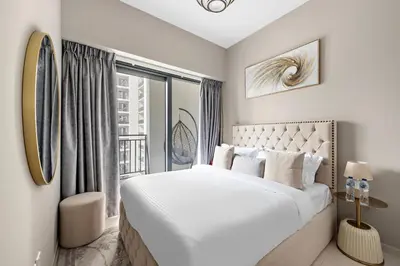 a white bedroom with a large bed and a window at ALiving Classy 1BR I Close to Dubai Mall I Zada Tower, Business Bay- 1617 in Dubai