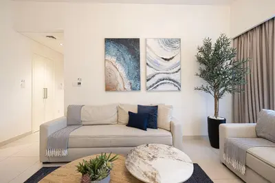 a living room with a couch and a table at Burj Crown - First Class Boulevard View, 9 min Walk Dubai Mall in Dubai