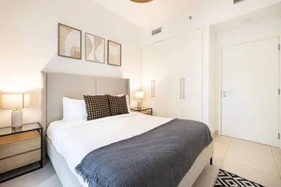 a bedroom with a large bed and two lamps at Burj Crown - First Class Boulevard View, 9 min Walk Dubai Mall in Dubai