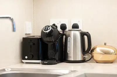 a kitchen counter with a coffee maker and a coffeemaker at Burj Crown - First Class Boulevard View, 9 min Walk Dubai Mall in Dubai