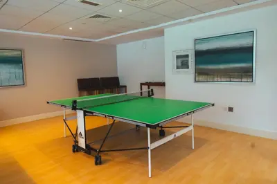 a ping pong table in an empty room at Luxury Studio, 29 Boulevard near Burj Khalifa Downtown - Chalet Homes in Dubai
