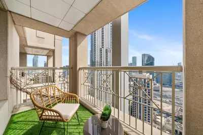 a balcony with a chair and a view of the city at Luxury Studio, 29 Boulevard near Burj Khalifa Downtown - Chalet Homes in Dubai