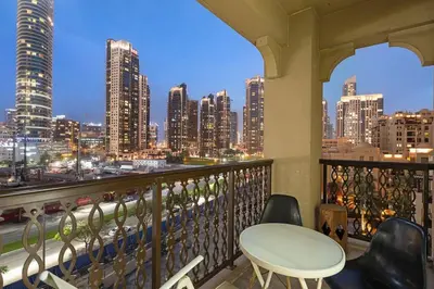 a balcony with a table and chairs and a city skyline at Stylish 1BR in Old Dubai Balcony, Smart TV, Full Kitchen in Dubai