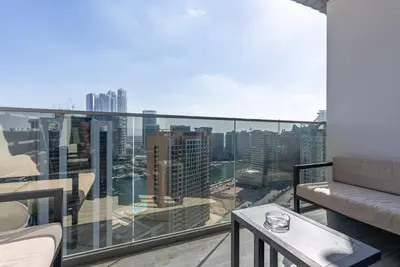 a balcony with a view of a city at MAG318, Modern Studio Apartment with Great Amenities and Canal View, 5min Walk to Dubai Mall in Dubai