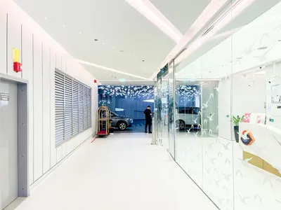 a hallway of a dealership with a car parked in a garage at MAG318, Modern Studio Apartment with Great Amenities and Canal View, 5min Walk to Dubai Mall in Dubai