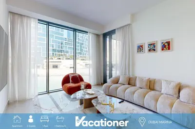 a living room with a couch and a chair at 5242 Tower 2 - Cosy One Bedroom in Dubai