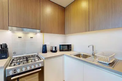 a kitchen with a sink and a stove top oven at 5242 Tower 2 - Cosy One Bedroom in Dubai