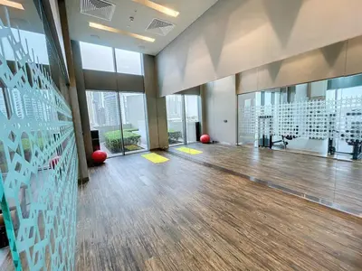 a large room with a wooden floor and large windows at 5242 Tower 2 - Cosy One Bedroom in Dubai