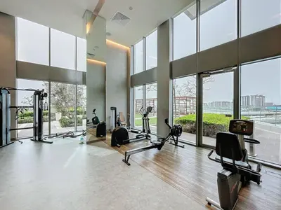 a gym with treadmills and exercise equipment in a building at 5242 Tower 2 - Cosy One Bedroom in Dubai