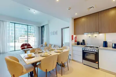 a kitchen and dining room with a table and chairs at 5242 Tower 2 - Cosy One Bedroom in Dubai