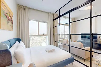 a living room with a couch and a window at Socio Tower 2 - Neat Two Bedroom in Dubai