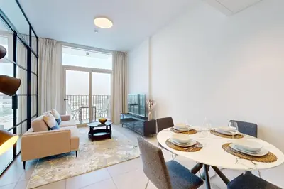 a living room with a table and chairs at Socio Tower 2 - Neat Two Bedroom in Dubai