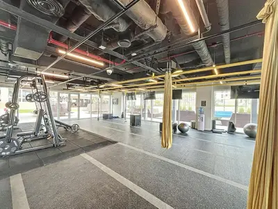 an empty gym with a fitness room with machines at Socio Tower 2 - Neat Two Bedroom in Dubai