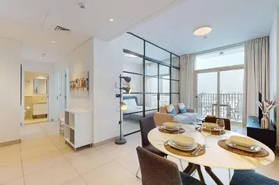 a living room with a dining table and a living room at Socio Tower 2 - Neat Two Bedroom in Dubai
