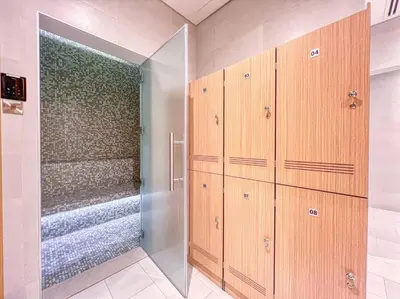 a bathroom with wooden cabinets and a walk in shower at Fantastic and Rare 4BR+maid's in JBR Walk in Dubai