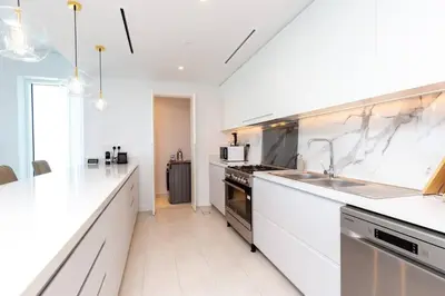 a large white kitchen with a sink and a stove at Fantastic and Rare 4BR+maid's in JBR Walk in Dubai