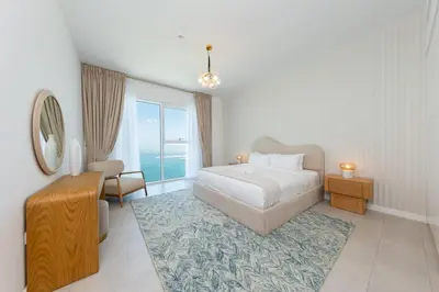 a bedroom with a bed and a large window at Fantastic and Rare 4BR+maid's in JBR Walk in Dubai