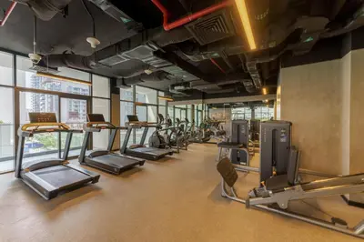 a gym with a row of treadms and cardio machines at Your Exclusive Retreat in Dubai Hills by Suiteable in Dubai