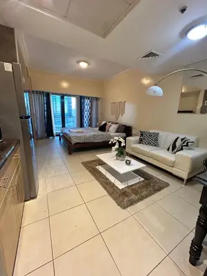 a living room with a couch and a table at Click Stay - JLT - Studio & Balcony Lakes view Entire Apartment -RA in Dubai
