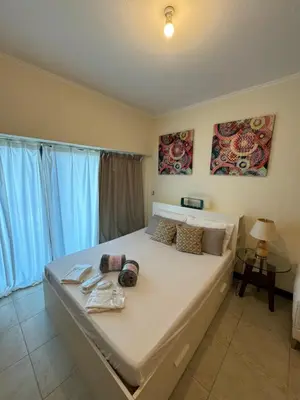 a bedroom with a large white bed in a room at Click Stay - JLT - Studio & Balcony Lakes view Entire Apartment -RA in Dubai