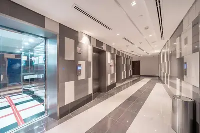 an empty hallway of a building with a window at StoneTree - Spacious Studio - The Matrix in Dubai
