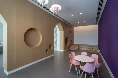 a dining room with a table and pink chairs at TH-Homes designed apartment Downtownview in Dubai