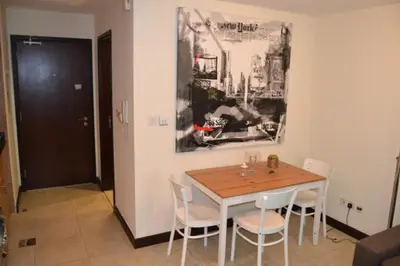 a dining room with a wooden table and chairs at Click Stay - JLT - Entire Studio & Balcony Lakes view Apartment -AM in Dubai