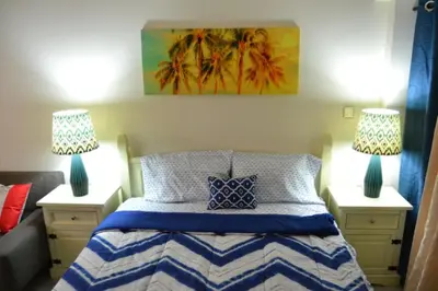 a bedroom with a bed with two lamps on both sides at Click Stay - JLT - Entire Studio & Balcony Lakes view Apartment -AM in Dubai