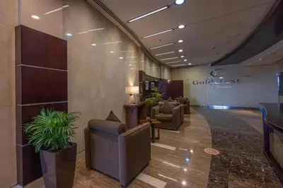a lobby with couches and plants in a building at Click Stay - JLT - Entire Studio & Balcony Lakes view Apartment -AM in Dubai