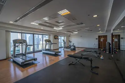 a gym with several treadmills and machines in a room at Click Stay - JLT - Entire Studio & Balcony Lakes view Apartment -AM in Dubai