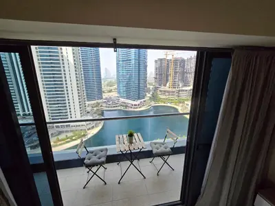 a balcony with chairs and a view of a city at Click Stay - JLT - Entire Studio & Balcony Lakes view Apartment -NA in Dubai