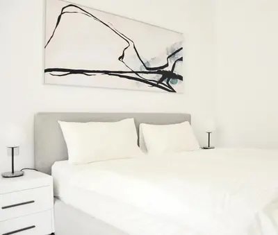 a bedroom with two beds and a painting on the wall at Sea Breeze Oasis in Dubai