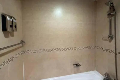 a bathroom with a shower and a white tub at Click Stay - JLT - Studio & Balcony Lakes view Entire Apartment -JN in Dubai