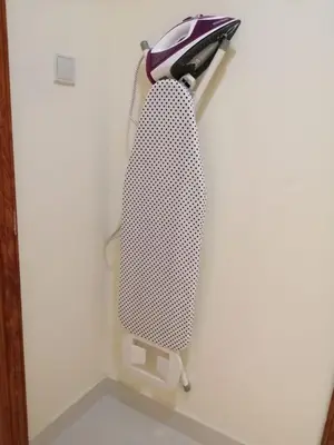 a black and white tie hanging on a wall at MOE Hostel By PHM in Dubai