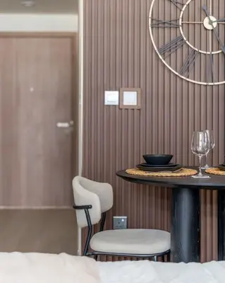 a table with two chairs and a wine glass at GuestReady - Urban Retreat in Downtown in Dubai
