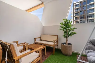 a balcony with a table and chairs and a tree at GuestReady - Urban Retreat in Downtown in Dubai