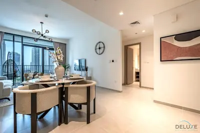 a dining room with a table and chairs at Beautiful 1BR in Creek Edge Tower 2, Dubai Creek Harbor by Deluxe Holiday Homes in Dubai