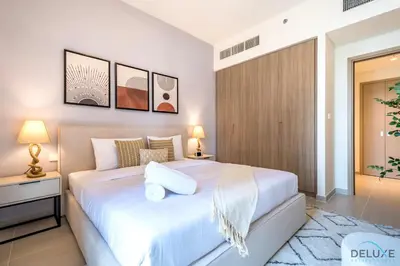a bedroom with a large white bed in a room at Beautiful 1BR in Creek Edge Tower 2, Dubai Creek Harbor by Deluxe Holiday Homes in Dubai