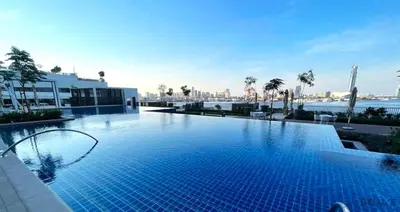 a large swimming pool on top of a building at Beautiful 1BR in Creek Edge Tower 2, Dubai Creek Harbor by Deluxe Holiday Homes in Dubai