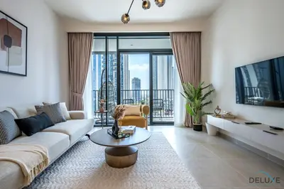 a living room with a couch and a table at Beautiful 1BR in Creek Edge Tower 2, Dubai Creek Harbor by Deluxe Holiday Homes in Dubai