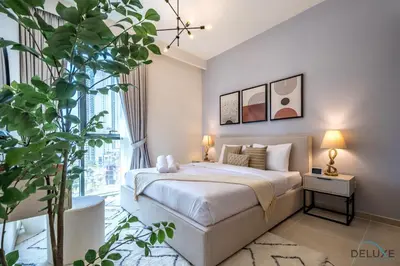 a bedroom with a bed and a large window at Beautiful 1BR in Creek Edge Tower 2, Dubai Creek Harbor by Deluxe Holiday Homes in Dubai