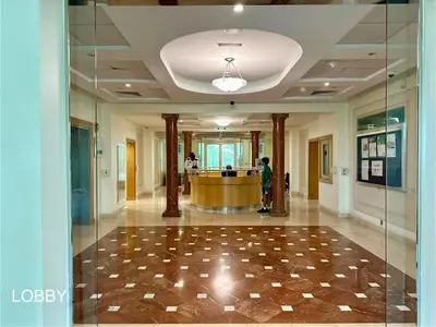 a lobby with a reception desk in a building at Bright 2BR Apartment with Garden View - Palm Jumeirah in Dubai