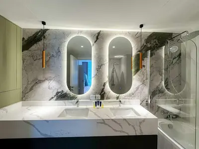 a bathroom with two sinks and two mirrors at Exquisite 1BR Hidden Gem - Oceana Residences in Dubai
