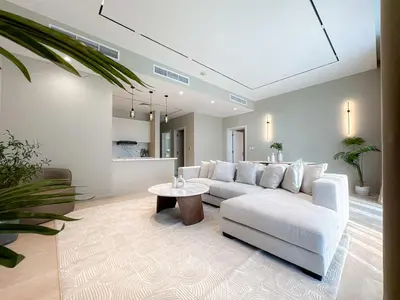 a living room with a white couch and a table at Exquisite 1BR Hidden Gem - Oceana Residences in Dubai