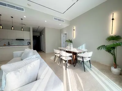 a living room with a table and a white couch at Exquisite 1BR Hidden Gem - Oceana Residences in Dubai