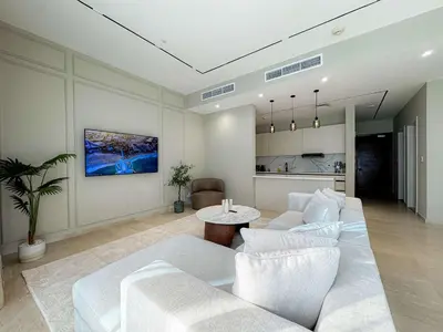 a living room with a white couch and a table at Exquisite 1BR Hidden Gem - Oceana Residences in Dubai